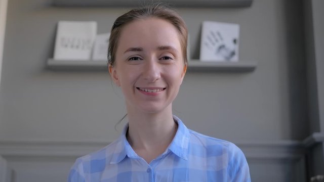 Portrait of woman blogger in plaid shirt looking at camera speaking, having video call, interview, conference recording vlog, training or webinar. Social media, online technology, blogging concept