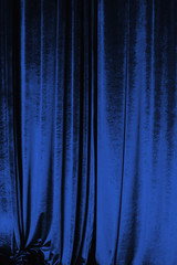Blue curtain of luxurious velvet on the theater stage. Copy space. The concept of music and...