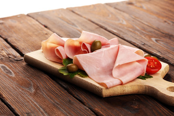 Sliced ham on wooden background. Fresh prosciutto cotto. Tasty Pork ham sliced