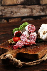 thinly sliced salami on a wooden texture on the background.