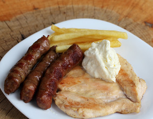 Grilled kebabs with white chicken meat file and French fries wit