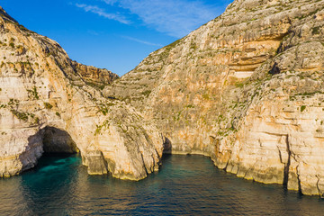 Fototapeta na wymiar Aerial view of Blue grotto, cave and cliffs. Blue clear sky, winter, rocks. Malta island