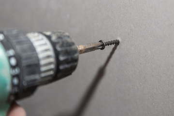 Working with an electric screwdriver.  Screw gun.