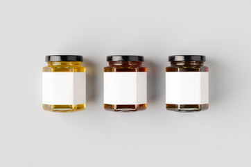 Hexagonal honey jars mockup with blank label. Three different colors.