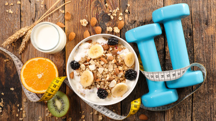 healthy lifestyle, breakfast with cerea and fruit, dumbbell