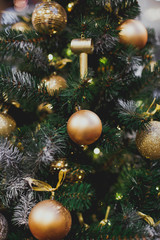 Obraz na płótnie Canvas Christmas background: green tree decorated with golden Christmas balls 