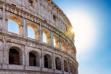Fototapeta na wymiar coliseum, facade backlight, sunset. facade of the Colosseum in backlight. ray of sunshine at sunset illuminates the arches of the famous Roman monument.