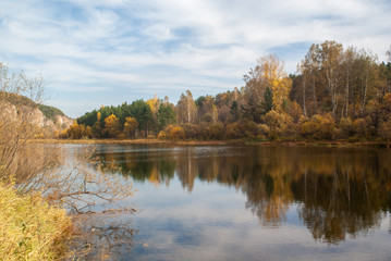 Fototapeta na wymiar Picturesque autumn forest on the bay. Siberia