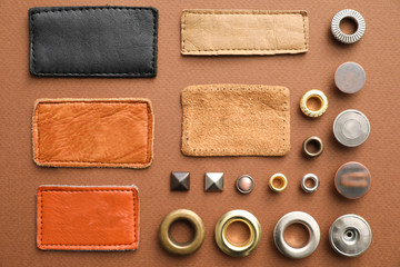 Flat lay composition with garment accessories for jeans on brown background