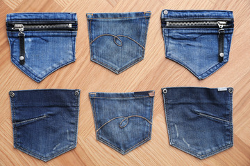 Flat lay composition with jeans pockets on table