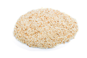 Heap of sesame seeds isolated on white background, side view.