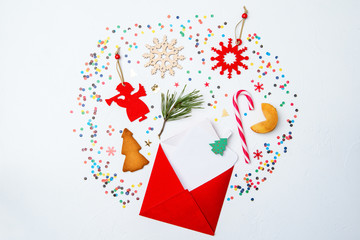 Image of red envelope, cookies, christmas decoration on white background