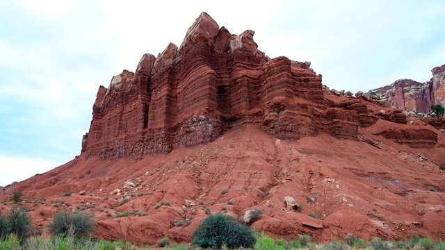 Scenic driving on road in slow motion Capitol Reef National Monument panning point of view of colorful stone red rock in Utah 