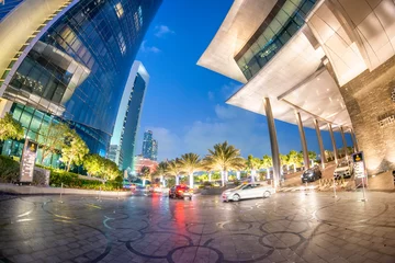 Foto op Canvas ABU DHABI, UAE - DECEMBER 8, 2016: Downtown buildings at night, wide angle view from the street © jovannig