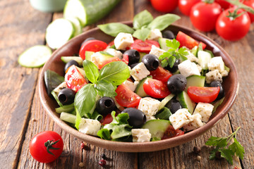 vegetable salad with feta cheese, tomato, olive and basil