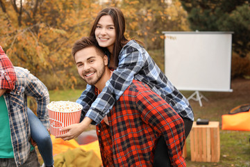 Young couple having fun in outdoor cinema