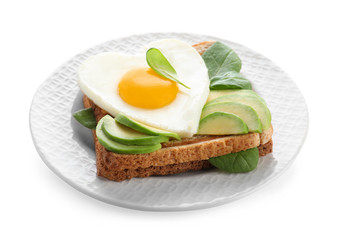 Plate of tasty breakfast with heart shaped fried egg isolated on white