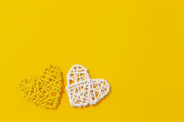 wooden stick heart shape on yellow background