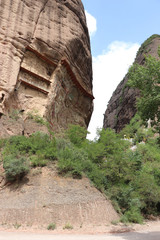Naklejka premium La Shao temple with giant 30-meter Buddha carved into rock at water Curtain Caves in Wushan , Gansu province, China. 