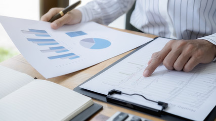 Business woman discussing the charts and graphs showing the results of their successful teamwork. Business concept.