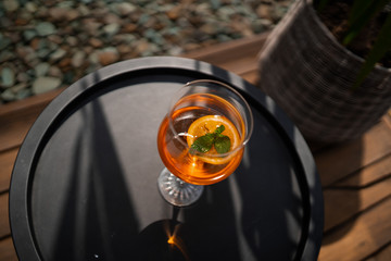 Aperol spritz cocktail in glass on table. italian alcoholic cocktail and white flowers isolated on wooden background. orange cocktail. Bar menu.
