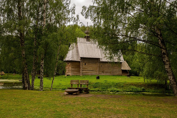 The old wooden Church is surrounded by birches. Kostroma, Russia.