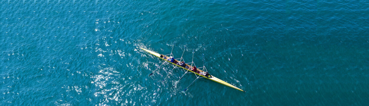 Aerial drone top panoramic view of sport canoe rowing synchronous athletes competing in tropical exotic lake © aerial-drone