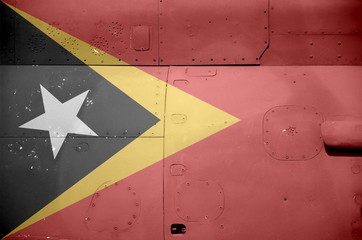 Timor Leste flag depicted on side part of military armored helicopter closeup. Army forces aircraft...