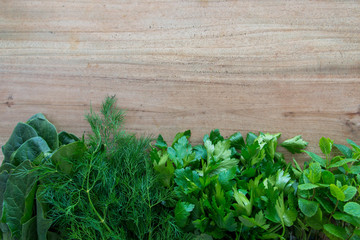 fresh herbs on wooden background dill parsley spinach mint . space for text 