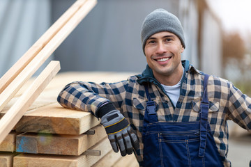 Young male worker in timber warehouse 