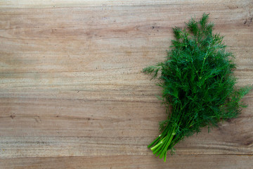 bunch of fresh parsley on wooden table. space for text 