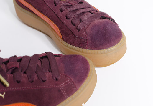 london, england, 05/07/2019 Puma Platform Trace Block Womens Cleated Suede Low Top Trainers. orange and burgundy colour. Vintage design with a modern twist, puma sneakers.