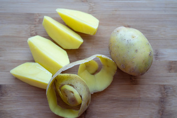 Raw potatoes with peel on a cutting Board