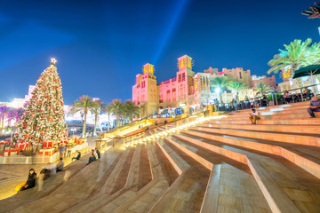 DUBAI, UAE - DECEMBER 9, 2016: Dubai Madinat Jumeirah at night with tourists and Christmas Tree