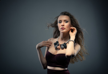 Woman in brown top and massive knitted accessories in studio