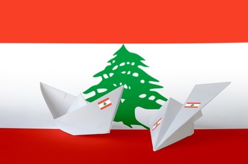 Lebanon flag depicted on paper origami airplane and boat. Handmade arts concept