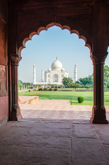 Taj Mahal mausoleum as seen through an arch (Agra, India) - 307634189