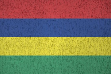 Mauritius flag depicted in bright paint colors on old relief plastering wall. Textured banner on...