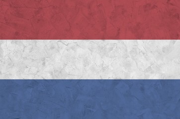 Netherlands flag depicted in bright paint colors on old relief plastering wall. Textured banner on...