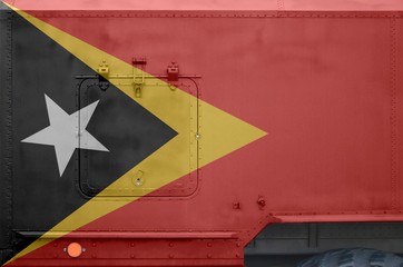 Timor Leste flag depicted on side part of military armored truck closeup. Army forces conceptual...