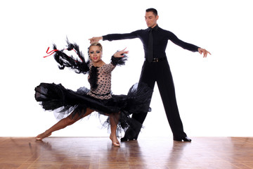Latino dancers in ballroom against white background