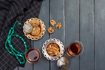 Nut balls dessert served with coffee on dark wooden table, top view