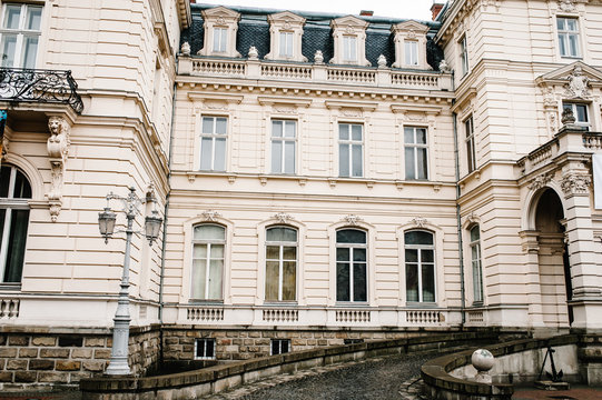 Ancient restored architecture, old building, old house outside, vintage palace outdoor. Facade of a building with windows.
