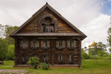 Fototapeta na wymiar Rural landscape. The old wooden house is surrounded by birches. Kostroma, Russia.Rural landscape. The old wooden house is surrounded by birches. Kostroma, Russia.