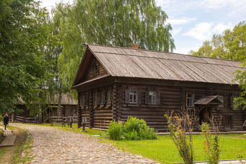 Rural landscape. The old wooden house is surrounded by birches. Kostroma, Russia.Rural landscape. The old wooden house is surrounded by birches. Kostroma, Russia.