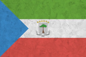 Equatorial Guinea flag depicted in bright paint colors on old relief plastering wall. Textured...