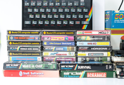 london, eng;and, 05/05/2019 A retro vintage nostalgic sinclair zx spectrum 48k 1980s computer console with games and retro joystick controllers on a white background.