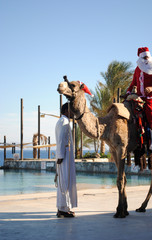 santa claus on camel and bedouin