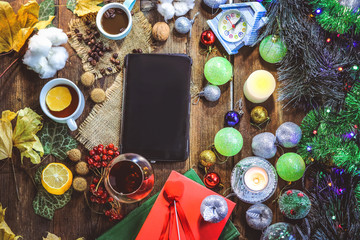 tablet computer on the background of Christmas decorations.