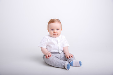 baby boy sitting on a white background. portrait of a child isolated on white background